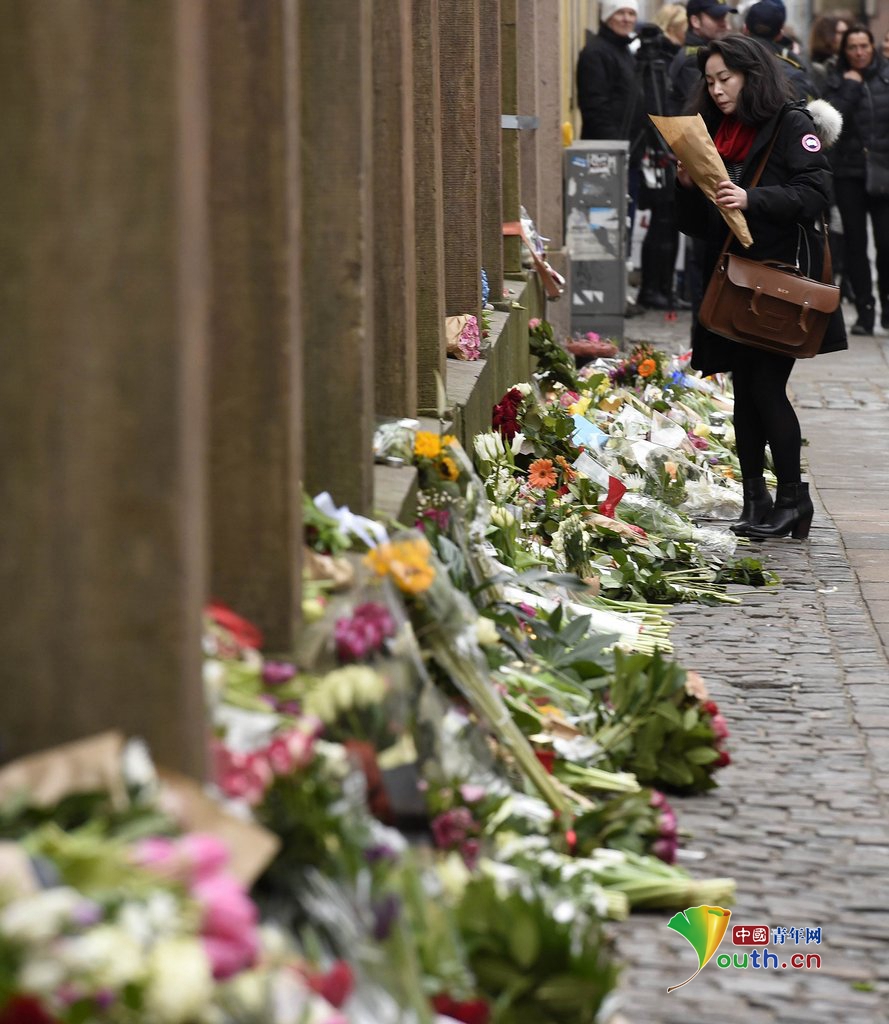 丹麦民众悼念两起枪击案遇难者