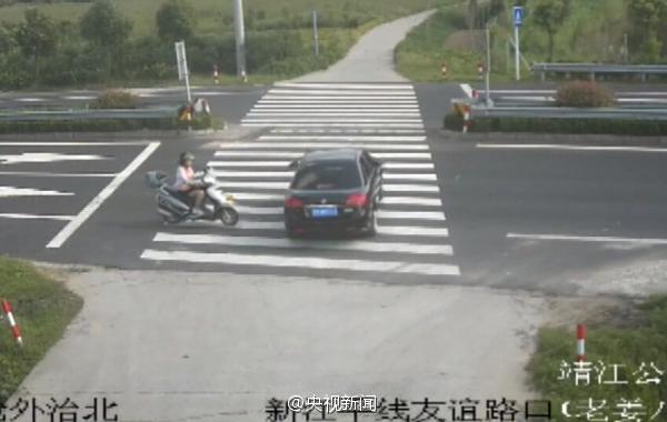 女子骑车玩手机 被轿车撞飞