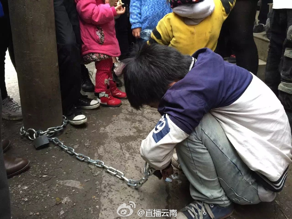 熊孩子被亲妈用铁链锁街头电线杆示众